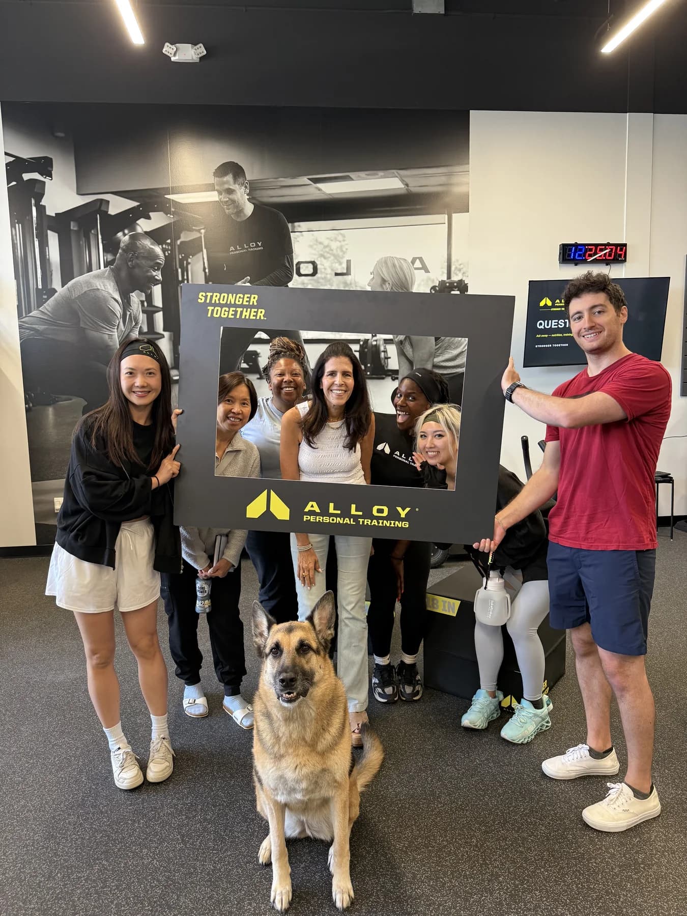 Members, coaches, and the studio dog posing together