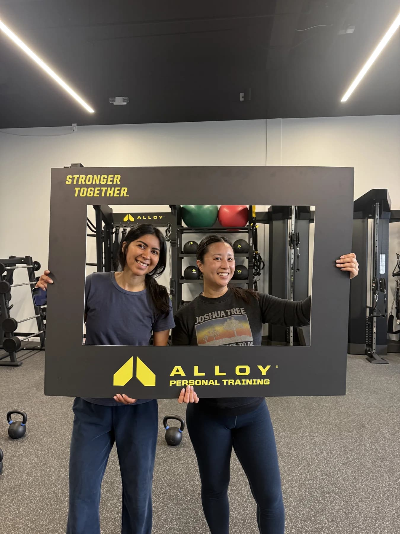 Two friends posing with the Alloy community frame