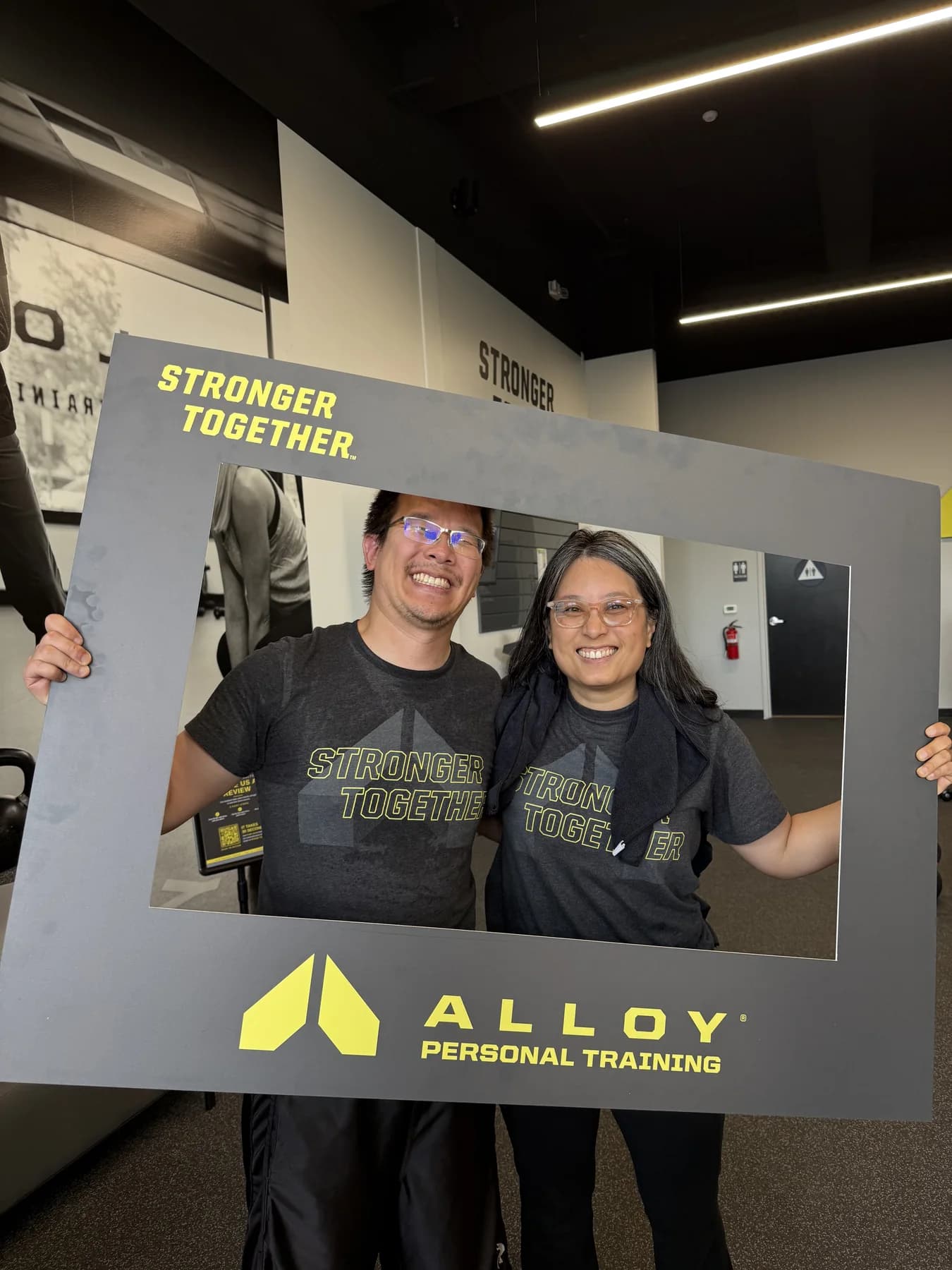 Two members posing together with the Stronger Together frame