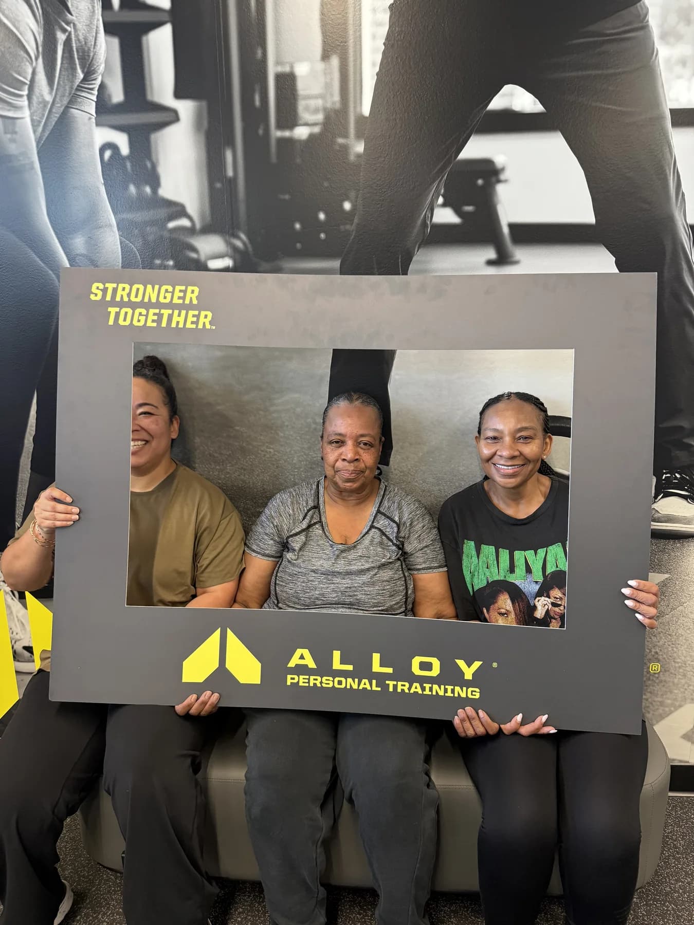 Three members posing together with the community photo frame