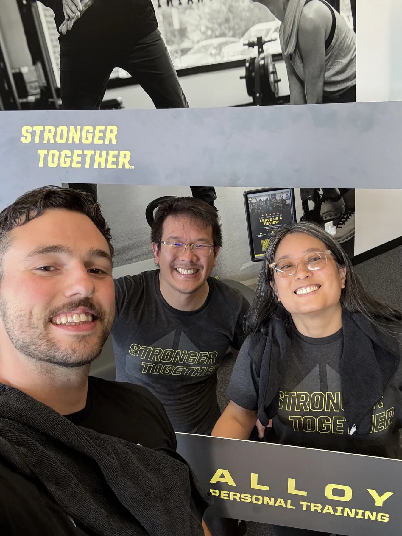 Three members and coaches smiling together after a session