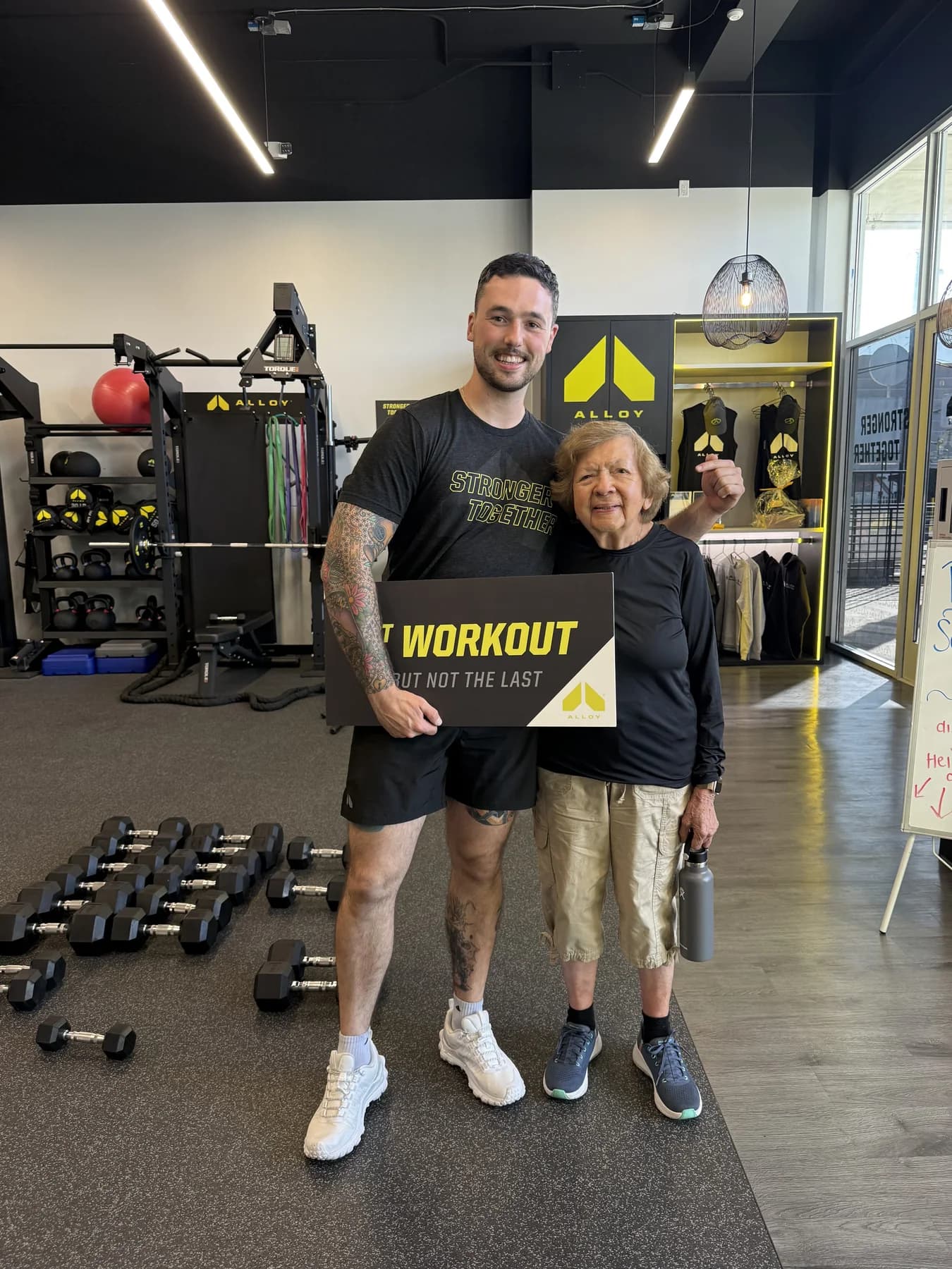 A coach and member celebrating the member's first workout