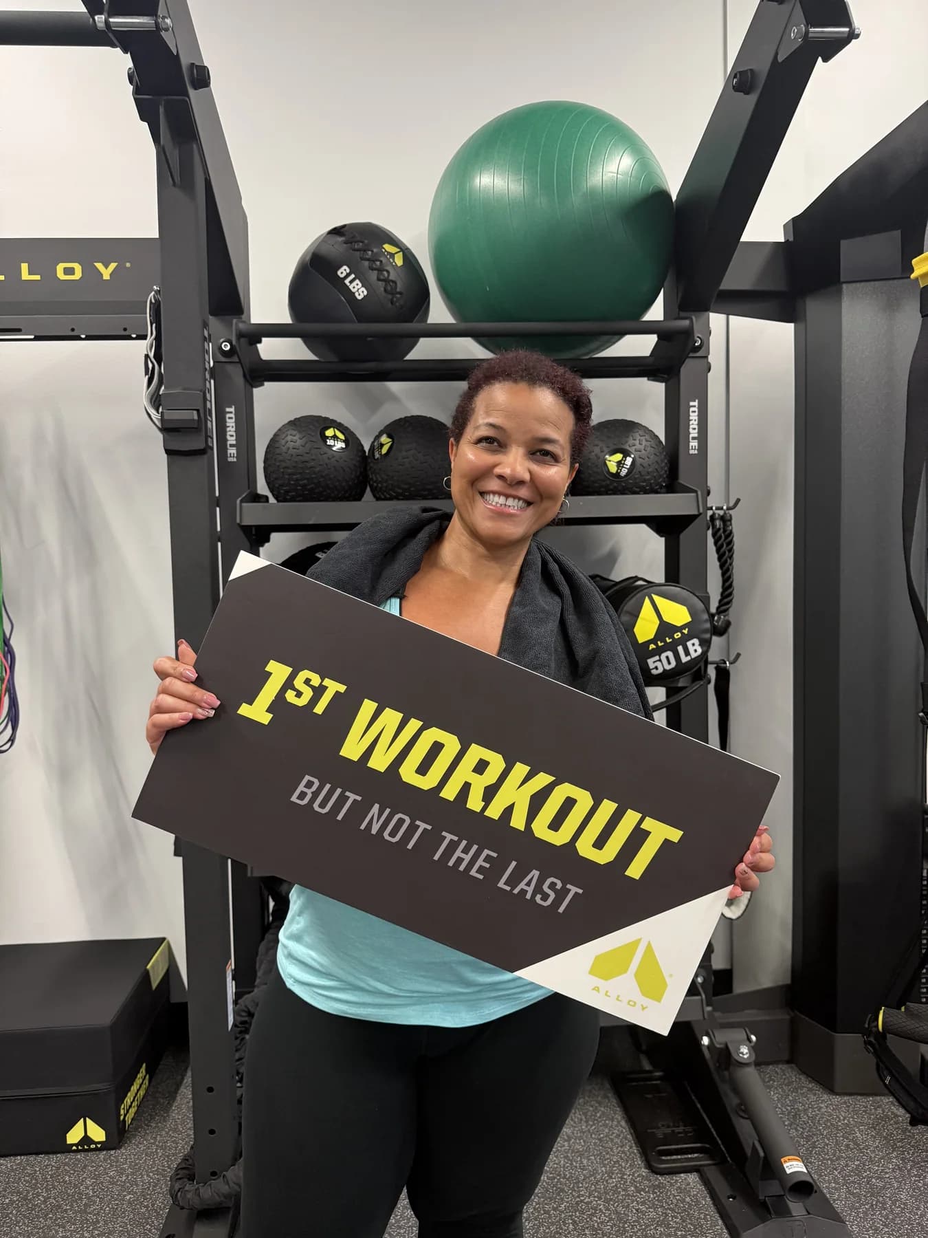 A member celebrating her first Alloy workout