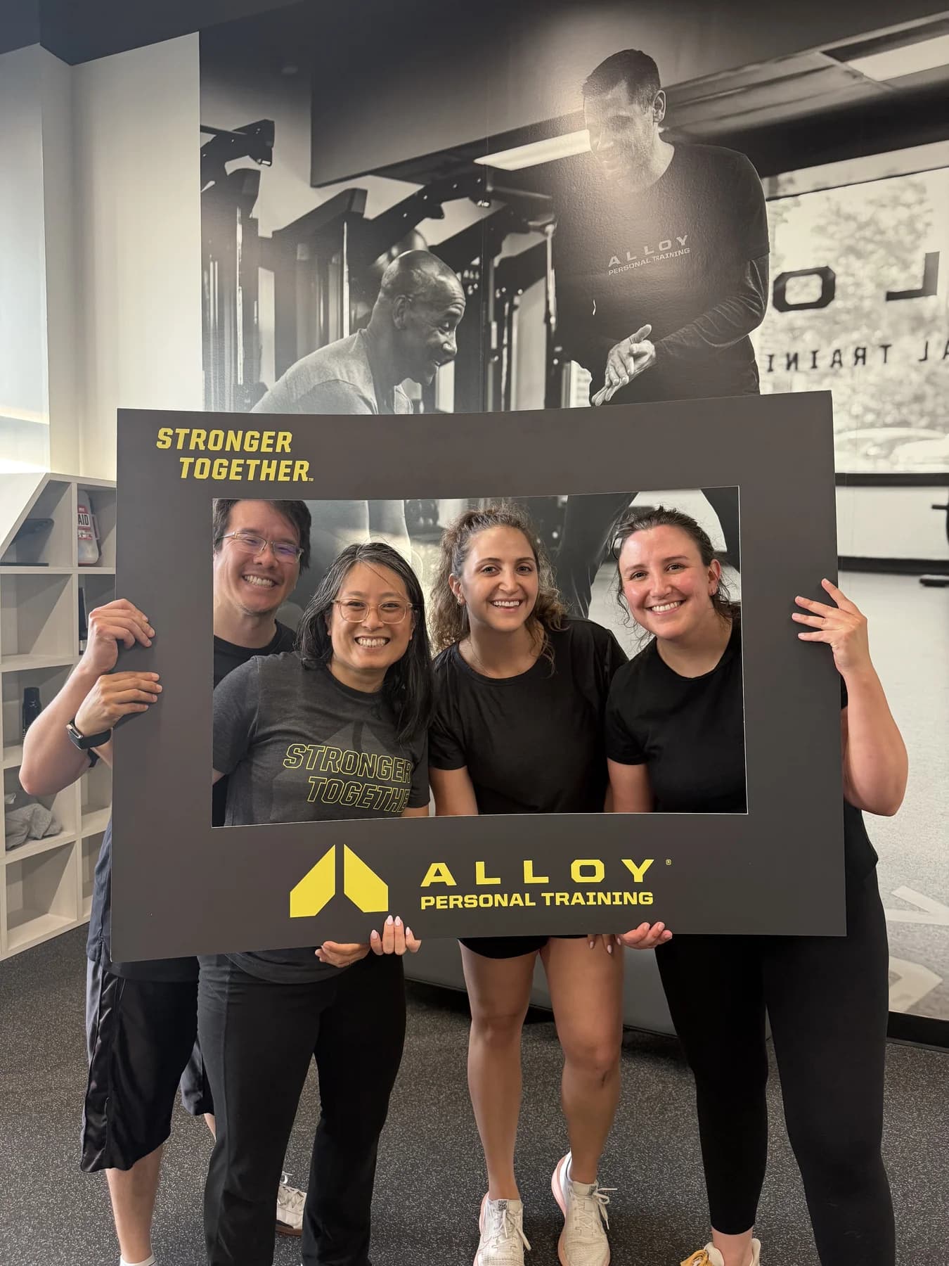 Two Alloy members celebrating with workout prizes in the studio