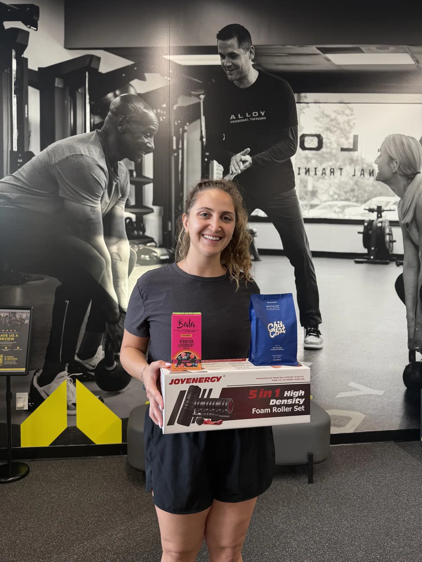 Two members celebrating together with workout prizes