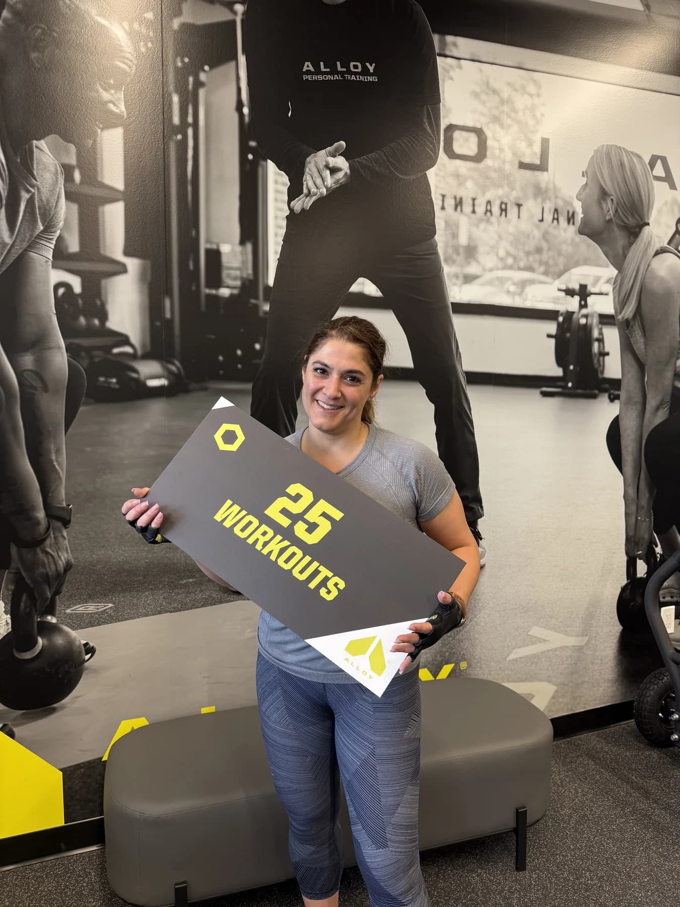 Two members celebrating a twenty-five-workout milestone