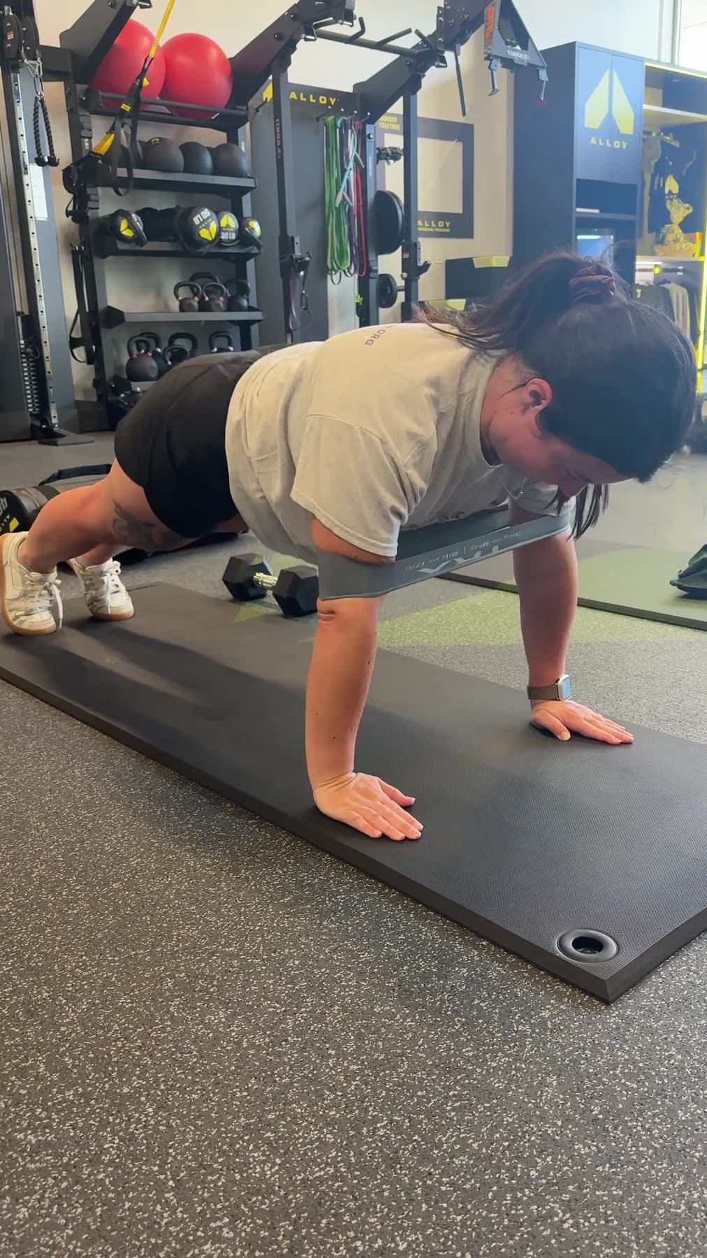 A member completing a push-up on the studio floor