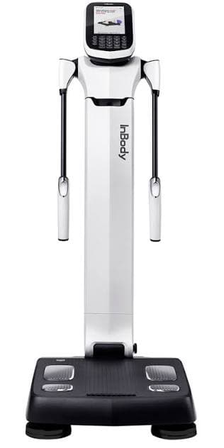 The InBody body composition scanner: a white column with a touchscreen at the top and a handrail on each side, standing on a black footplate